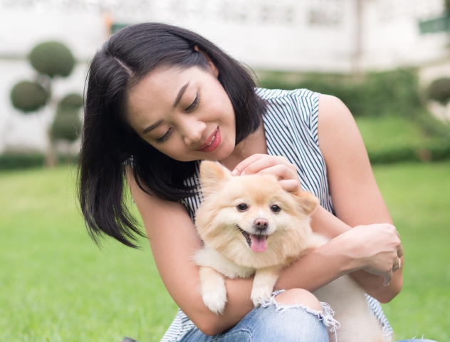 Female pet owner hugging their cherished pet dog