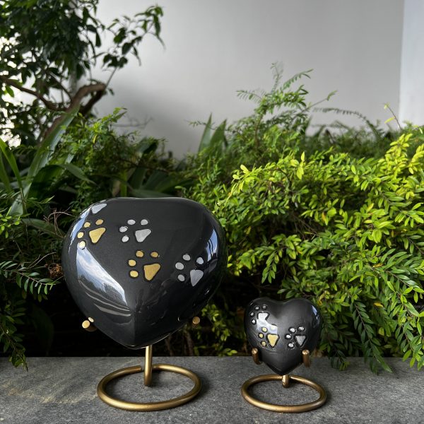 Black Heart-shaped Pet Urn with brass stand and paw print decoration
